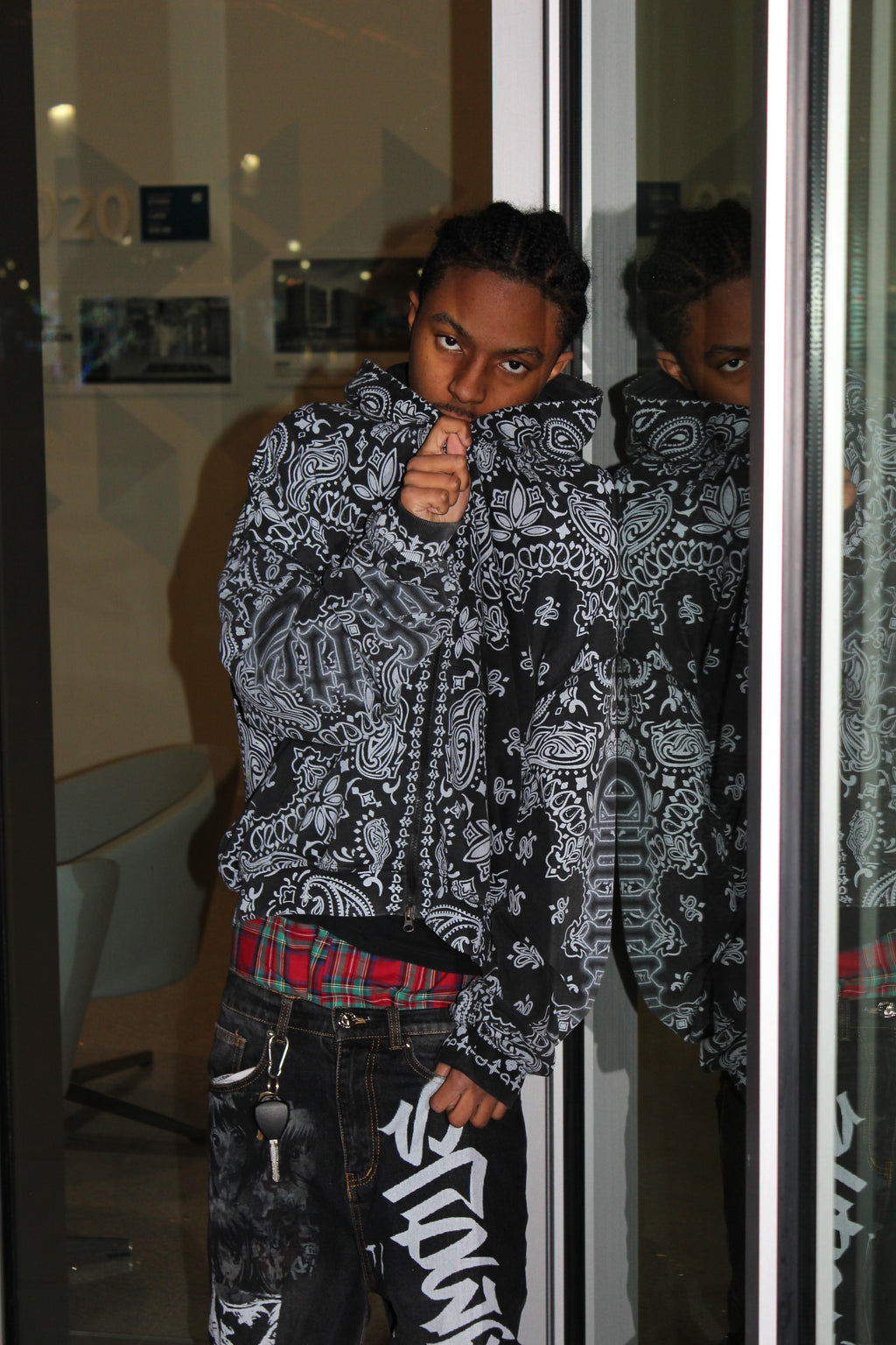 Person wearing a paisley-patterned CuttinUp jacket and pants in a reflective indoor setting